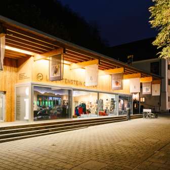 Modernes Besucherzentrum mit Glasfront in Vaduz bei Nacht, einladend beleuchtet