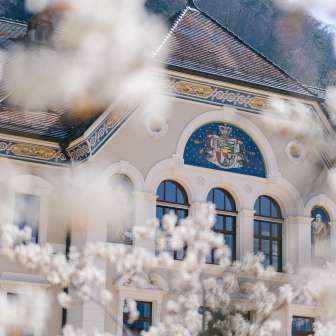 Government building framed by flowering trees in spring