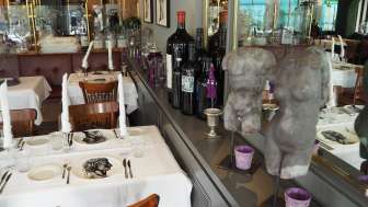 Interior shot of the Ristorante Cesare with set tables and other decorations