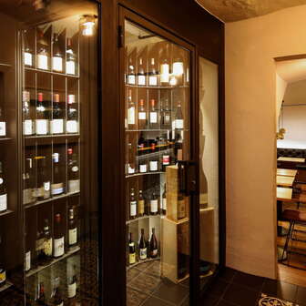 Modern wine cabinet with fine bottles in the stylish WY wine bar, view of the adjacent tasting room.
