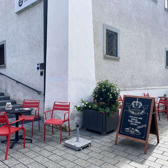Red tables and chairs in front of the Liechtenstein National Museum