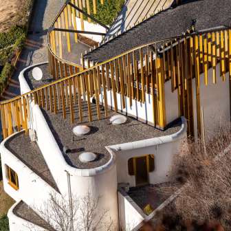 Aerial view of the artfully curved roof and golden façade elements of the Centre for Art in Vaduz.